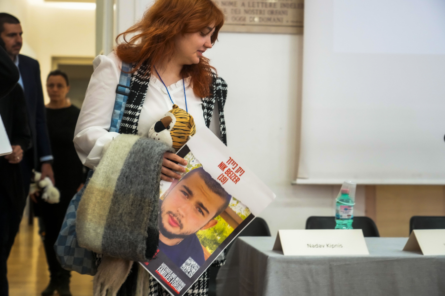 Nkol, 15-year-old sister of Nik Beizer, an IDF soldier stationed at the Erez District Coordination Office and who is one of the over 220 hostages believed to be held by Hamas in Gaza, holds a poster with a photograph of her 19-year-old brother as she arrives for a press conference at the Italian Jewish Center in Rome, Wednesday, Nov. 22, 2023, with other representatives of the families of the Israelis abducted by Hamas militants on Oct. 7, shortly after they met with Pope Francis at The Vatican. Beizer was abducted by Hamas militants during the group&rsquo;s unprecedented attack on Israel on Oct. 7 which resulted in the killing of 1,400 people and the abduction of over 220.