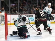Seattle Kraken goaltender Joey Daccord, left, gives up a goal to Arizona Coyotes&rsquo; Clayton Keller as Coyotes center Barrett Hayton (29) and Kraken defenseman Jamie Oleksiak (24) look on during the third period of an NHL hockey game Tuesday, Nov. 7, 2023, in Tempe, Ariz. The Coyotes won 4-3 in a shootout. (AP Photo/Ross D.
