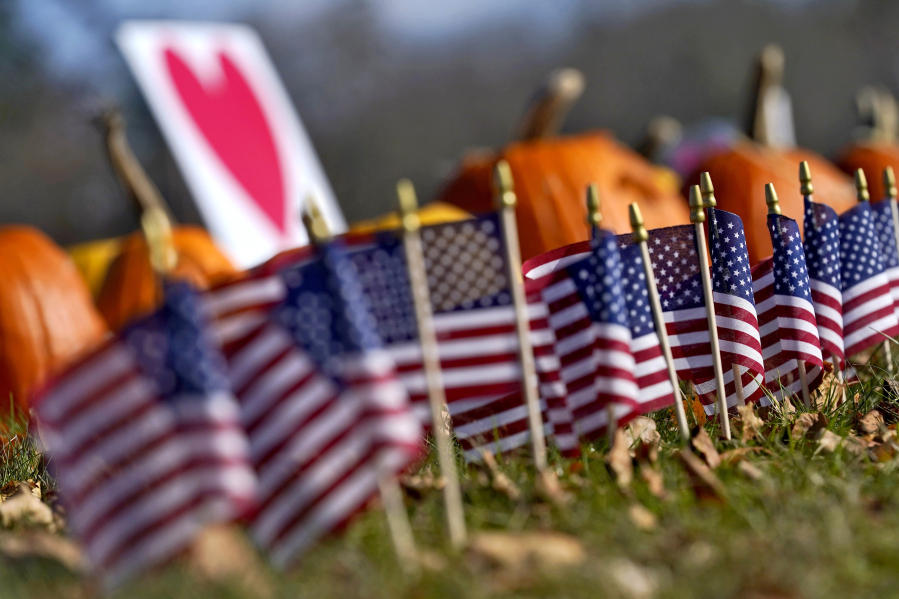 Pumpkins and flags line the curbside outside Sparetime Bowling, Friday, Nov. 3, 2023, Lewiston, Maine, prior to the arrival of President Joe Biden. Biden is heading to Lewiston to mourn with the community after multiple people were killed in the deadliest mass shooting in state history. The bowling alley was recently renamed Just-In-Time Recreation.