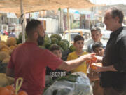 This image released by ABC News Studios shows Bob Woodruff, right, in the marketplace in Sabaa Al Bour, Iraq. Woodruff has returned to the Iraqi roadside where a bomb nearly killed him while on assignment for ABC News in 2006.  &ldquo;After the Blast: The Will to Survive,&rdquo; which airs on ABC Friday at 8 p.m. Eastern and begins streaming on Hulu a day later.