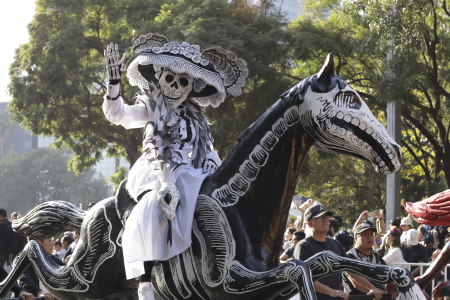 A participant takes part in a James Bond-inspired Day of the Dead Parade, in Mexico City, Saturday, Nov. 4, 2023.