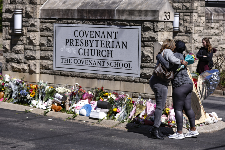 FILE - Two women hug near a memorial at the entrance to The Covenant School, March 29, 2023, in Nashville, Tenn. The Tennessee Court of Appeals heard arguments Monday, Oct. 16, on whether Tennessee law gives the parents of school shooting victims the right to have a say over which police records are released to the public.