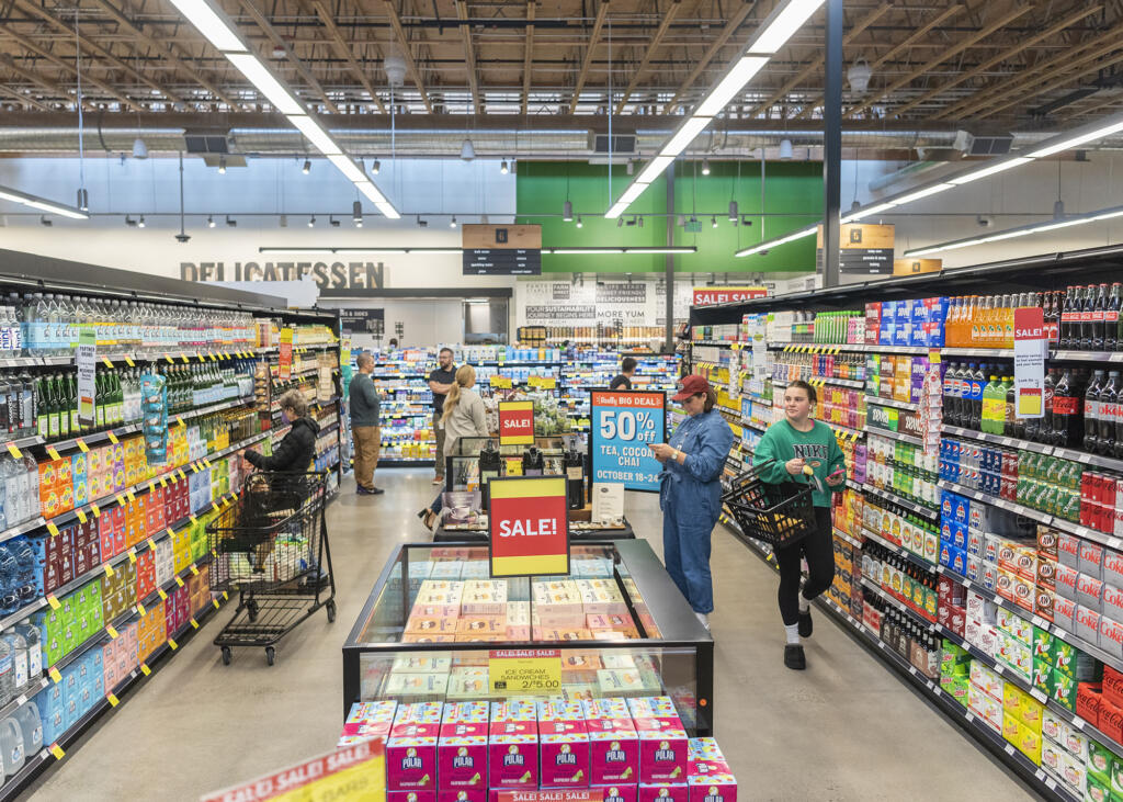 Shoppers browse the shelves at the grand opening of the downtown Vancouver New Seasons. Clark County employers added 1,200 jobs in October, with the latest labor report showing year-over-year growth in virtually every sector of the economy.