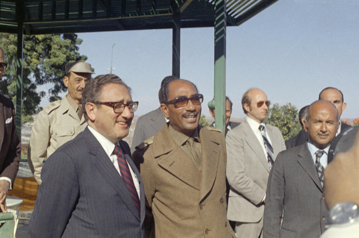 FILE - U.S. Secretary of State Henry Kissinger, left, and Egypt&rsquo;s President Anwar Sadat in Cairo, Egypt, Jan. 16, 1974. Former Secretary of State Henry Kissinger, the diplomat with the thick glasses and gravelly voice who dominated foreign policy as the United States extricated itself from Vietnam and broke down barriers with China, died Wednesday, Nov. 29, 2023,his consulting firm said.