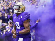 Washington quarterback Michael Penix Jr. yells as he runs out during introductions before an NCAA college football game against Oregon, Saturday, Oct. 14, 2023, in Seattle.
