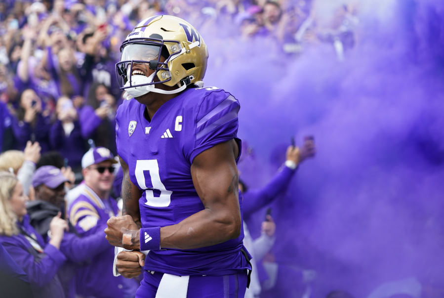 Washington quarterback Michael Penix Jr. yells as he runs out during introductions before an NCAA college football game against Oregon, Saturday, Oct. 14, 2023, in Seattle.