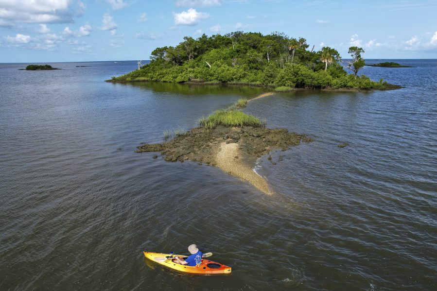 Associated Press reporter Richard Lardner kayaks to Sweetheart Island, off the coast of Yankeetown, Fla., on Aug. 5, 2023. Patrick Parker Walsh is serving five and half years in federal prison for stealing nearly $8 million in federal COVID-19 relief funds that he used, in part, to buy the island.