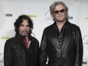 FILE - Hall of Fame Inductees, Hall &amp; Oates, John Oates and Daryl Hall appear in the press room at the 2014 Rock and Roll Hall of Fame Induction Ceremony on April, 10, 2014, in New York.  Hall has sued his longtime music partner John Oates, arguing that his plan to sell off his share of a joint venture would violate a business agreement the duo had.