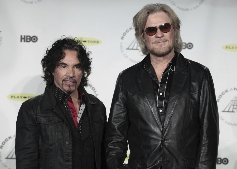 FILE - Hall of Fame Inductees, Hall &amp; Oates, John Oates and Daryl Hall appear in the press room at the 2014 Rock and Roll Hall of Fame Induction Ceremony on April, 10, 2014, in New York.  Hall has sued his longtime music partner John Oates, arguing that his plan to sell off his share of a joint venture would violate a business agreement the duo had.