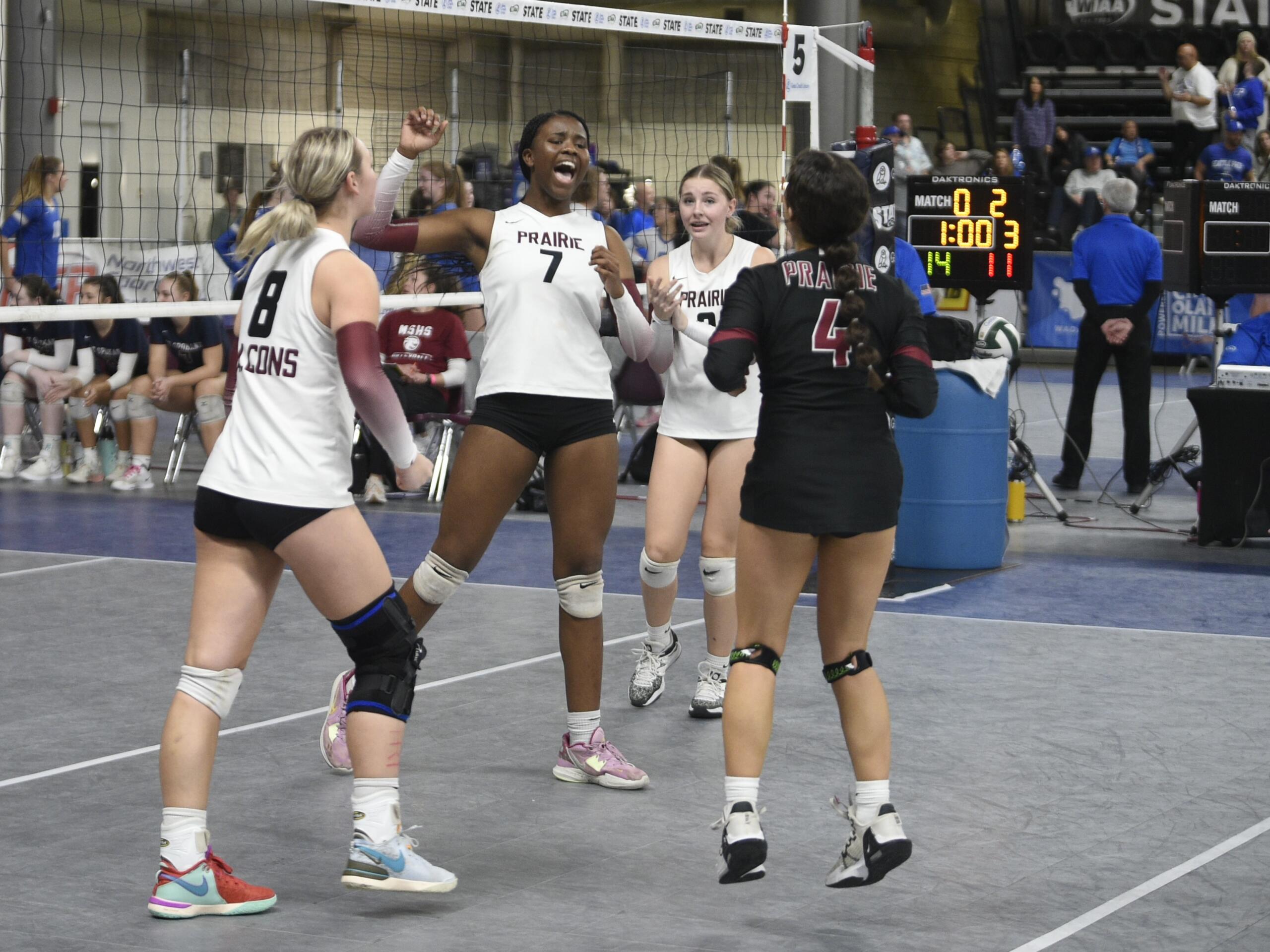 Prairie's Diamond Doutrive (7) celebrates with teammates during a Class 3A state volleyball tournament match against Mt. Spokane on Saturday, Nov.