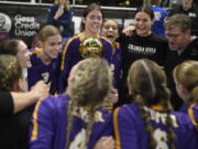 Columbia River's Lauren Dreves holds the Class 2A volleyball state championship trophy after the title match against Ridgefield on Saturday, Nov, 11, 2023 in Yakima.