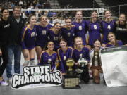 The Columbia River volleyball team poses with the  Class 2A state championship trophy after the title match against Ridgefield on Saturday, Nov, 11, 2023 in Yakima.