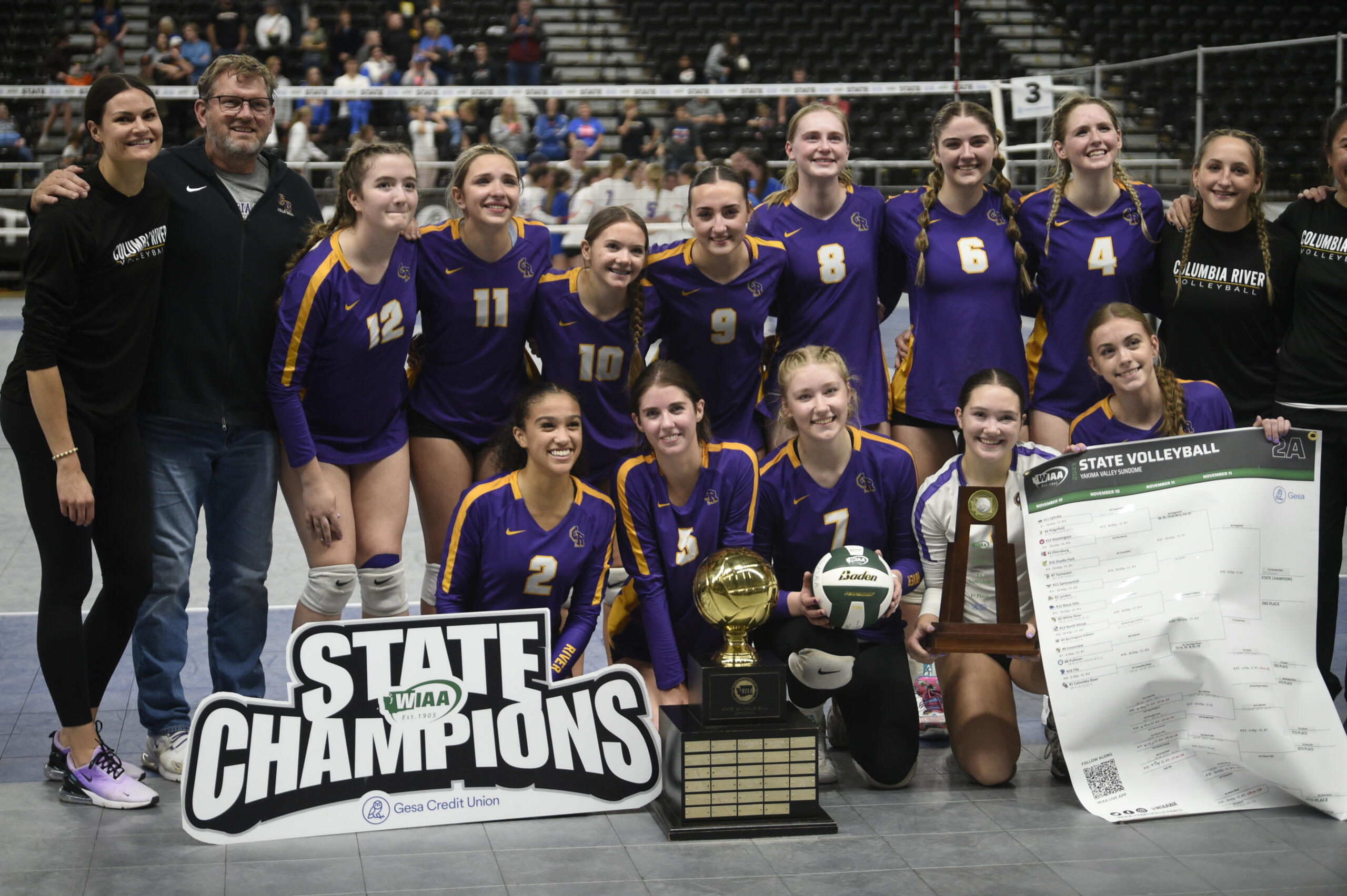 The Columbia River volleyball team poses with the  Class 2A state championship trophy after the title match against Ridgefield on Saturday, Nov, 11, 2023 in Yakima.