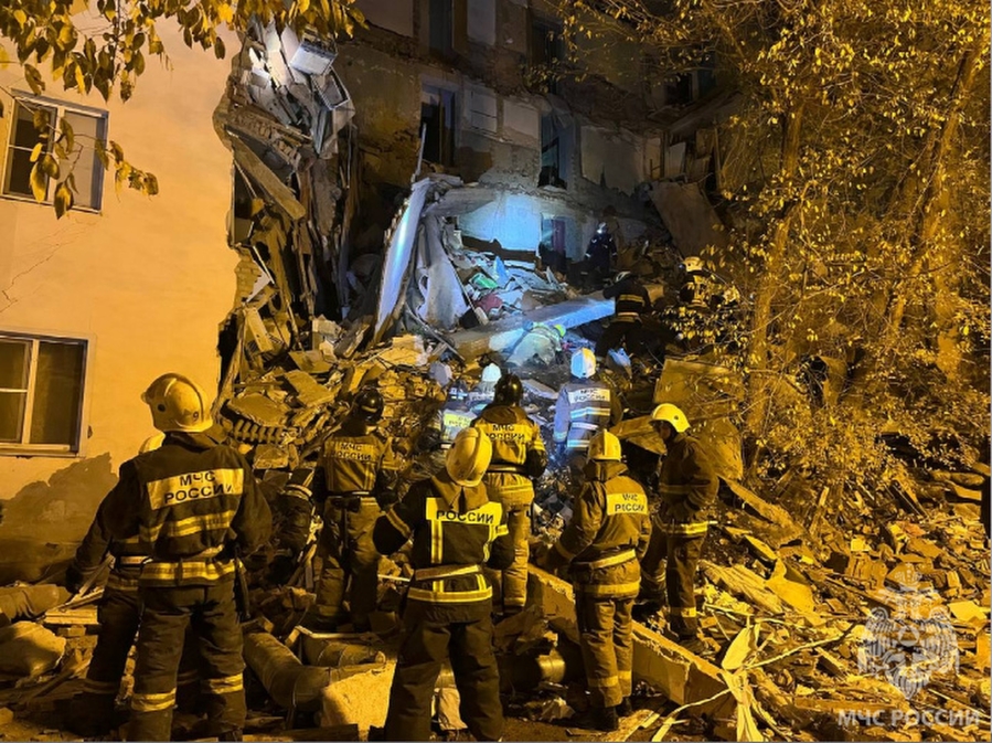 In this photo released by Russian Emergency Ministry Press Service on Thursday, Nov. 16, 2023, Russian Emergency Ministry work at the side of a five-storey building partially collapsed in Astrakhan, Russia. Part of a residential building has collapsed in southern Russia, killing one woman and sparking a search and rescue operation, Russian state news agency Tass said. Before part of the building in the southern city of Astrakhan collapsed, the Ministry of Emergency Situations said it had received information about cracks appearing.