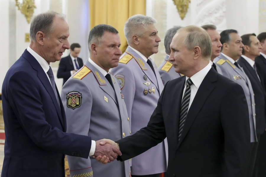 FILE - Russian President Vladimir Putin shakes hands with Russian Security Council chairman Nikolai Patrushev, left, as he greets senior military officers during a meeting in Moscow, Russia, Wednesday, Nov. 6, 2019. Patrushev could be an establishment-supported candidate for Russian president if Vladimir Putin does not run for reelection or becomes incapacitated before the vote in March 2024.