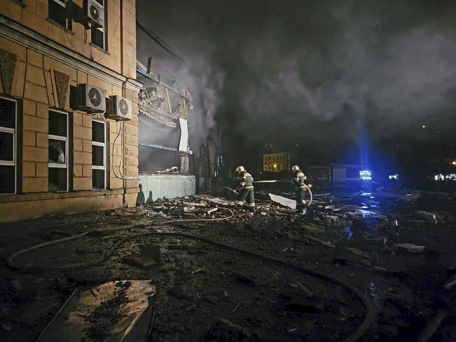 In this photo provided by Odesa City Administration, Ukrainian emergency workers examine the site of a Russian rocket attack in central Odesa, Ukraine, early hours on Monday, Nov. 6, 2023.