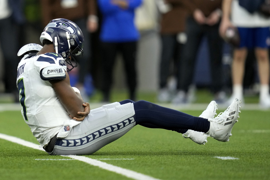 Seattle Seahawks quarterback Geno Smith (7) sits on the field after being injured during the second half of an NFL football game against the Los Angeles Rams Sunday, Nov. 19, 2023, in Inglewood, Calif.