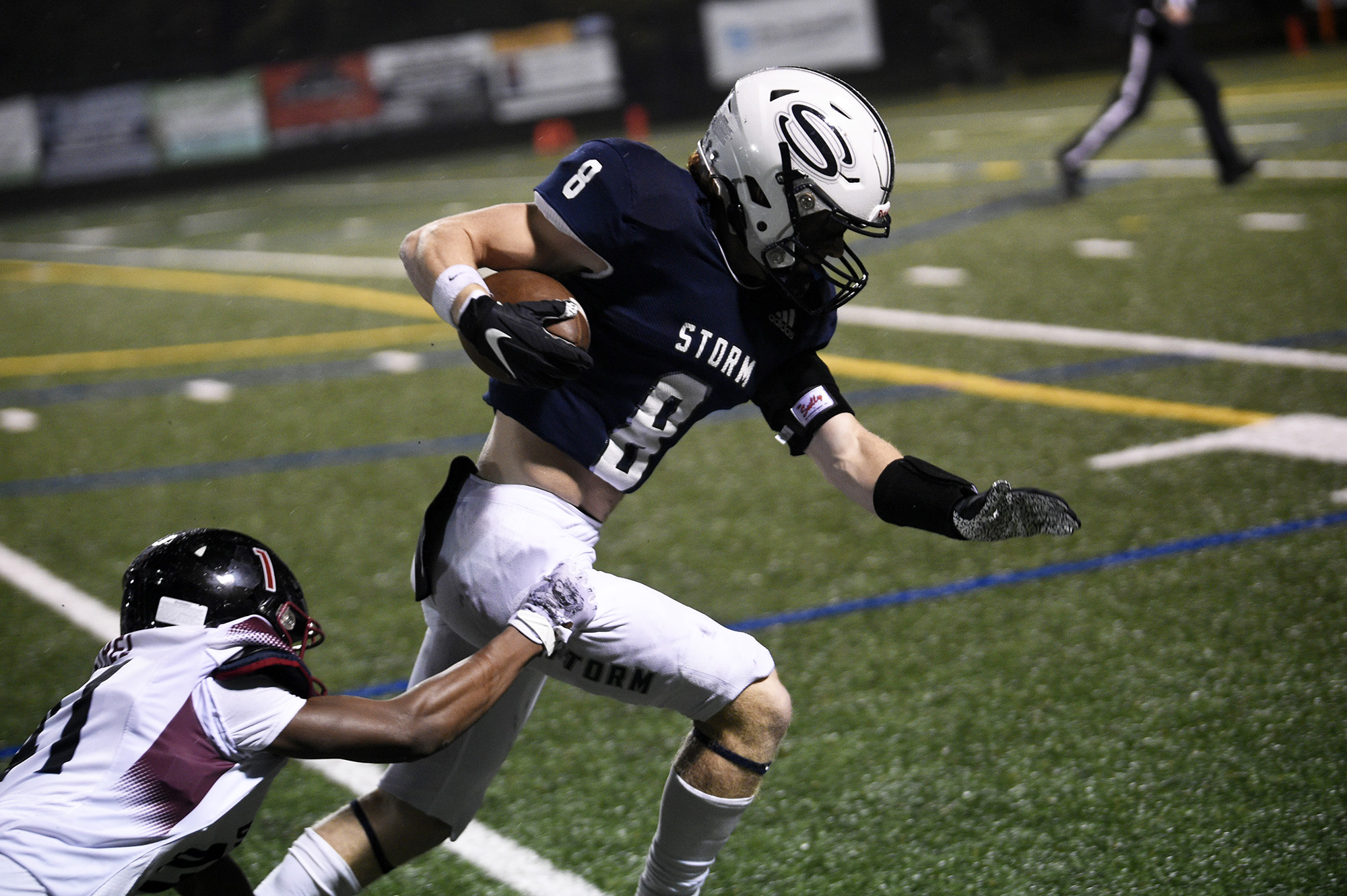 Skyview’s Gavin Packer (8) slips through the tackle of Bethel’s Jordan Williams (left) on his way to scoring a 36-yard touchdown pass play in the Storm’s 49-21 win over Bethel at Kiggins Bowl on Friday, Nov. 3, 2023.