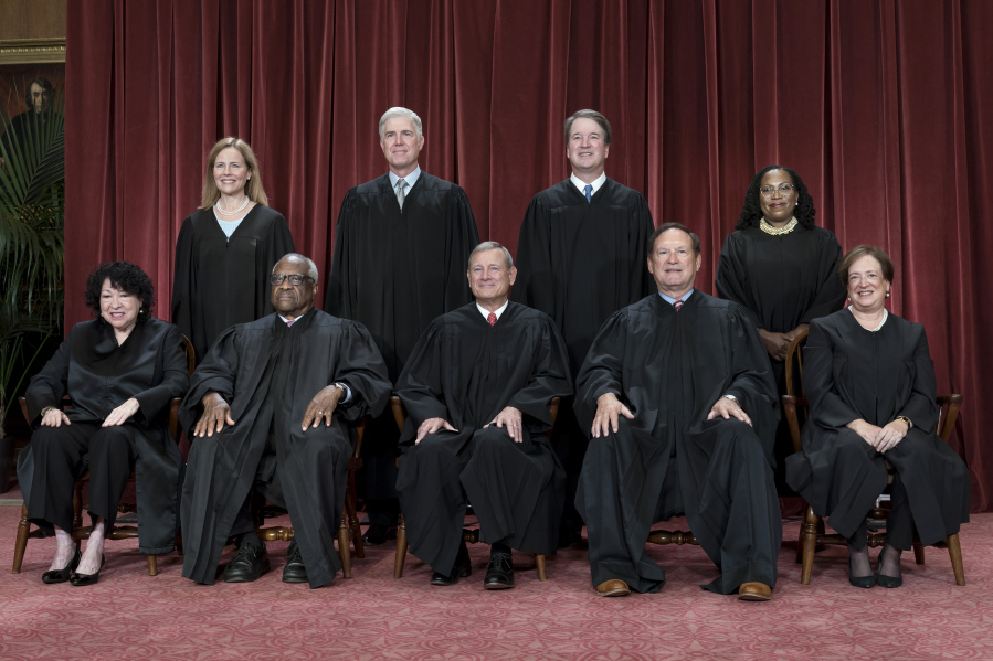 FILE - Members of the Supreme Court sit for a new group portrait following the addition of Associate Justice Ketanji Brown Jackson, at the Supreme Court building in Washington, Oct. 7, 2022. Bottom row, from left, Justice Sonia Sotomayor, Justice Clarence Thomas, Chief Justice John Roberts, Justice Samuel Alito, and Justice Elena Kagan. Top row, from left, Justice Amy Coney Barrett, Justice Neil Gorsuch, Justice Brett Kavanaugh, and Justice Ketanji Brown Jackson. The Supreme Court is adopting its first code of ethics, in the face of sustained criticism over undisclosed trips and gifts from wealthy benefactors to some justices. The policy was issued by the court Monday.  (AP Photo/J.