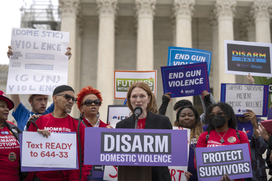 Actor Julianne Moore speaks during a rally at the Supreme Court on Tuesday, Nov. 7, 2023, in Washington. The Supreme Court is taking up a challenge to a federal law that prohibits people from having guns if they are under a court order to stay away from their spouse, partner or other family members.