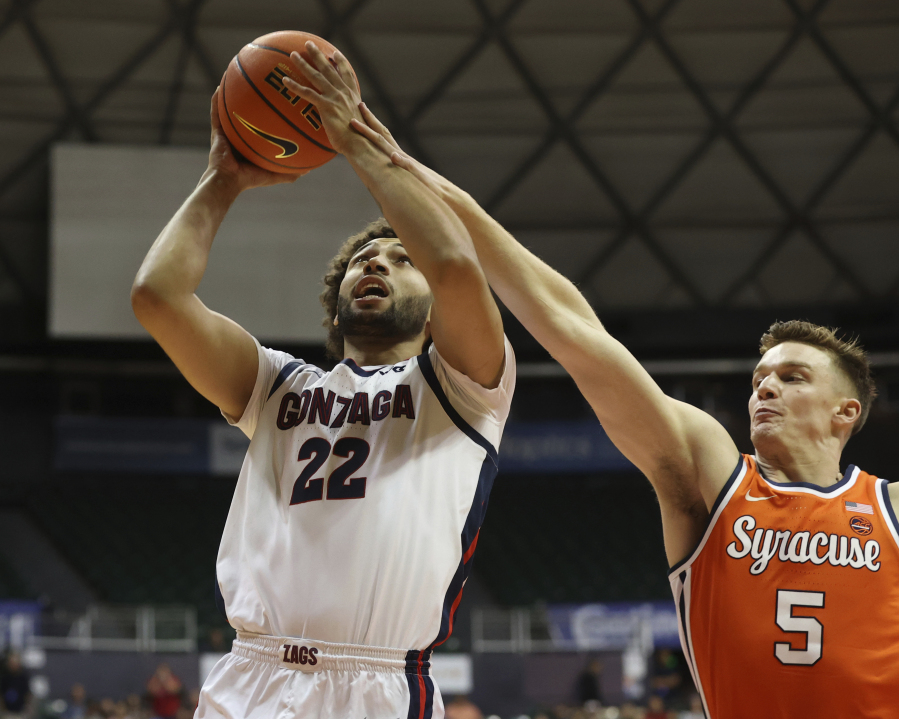 Gonzaga forward Anton Watson (22) goes to the net over Syracuse guard Justin Taylor (5) during the first half of an NCAA college basketball game, Tuesday, Nov. 21, 2023, in Honolulu.