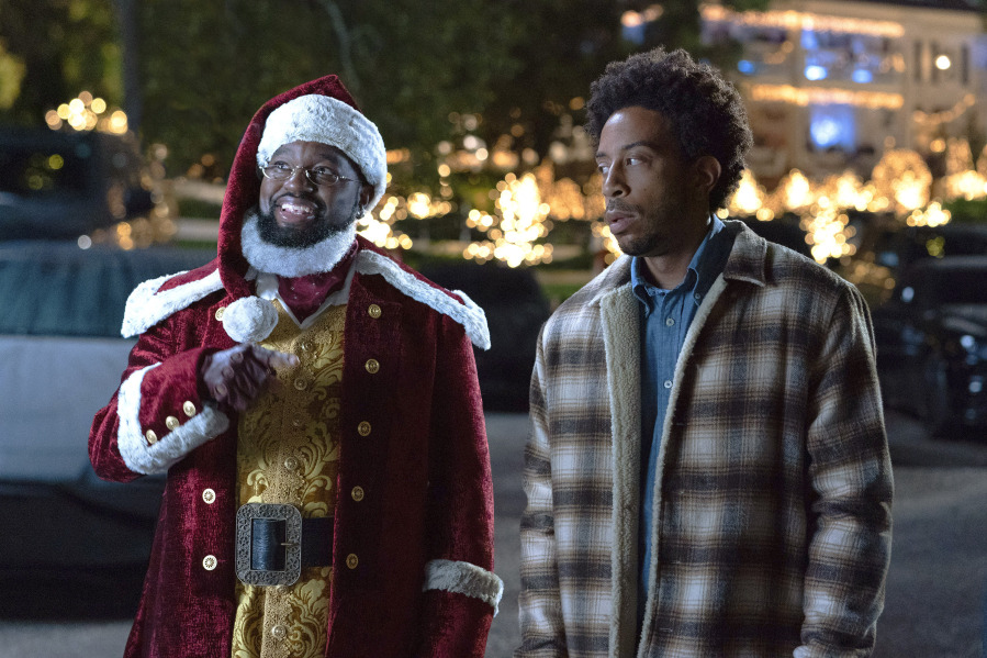 This image released by Disney+ shows Lil Rel Howery as Nick, left, and Chris &ldquo;Ludacris&rdquo; Bridges as Eddie in a scene from the holiday special &ldquo;Dashing Through the Snow.&rdquo; (Steve Dietl/Disney+ via AP) (Stephanie Mei-Ling/Universal Pictures/Peacock)