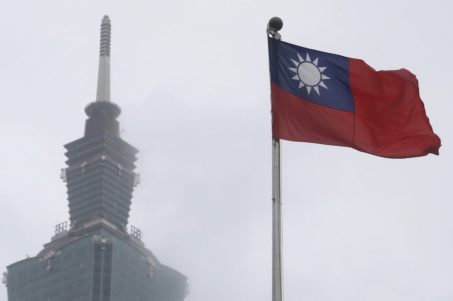 FILE - A Taiwan national flag flutters near the Taipei 101 building at the National Dr. Sun Yat-Sen Memorial Hall in Taipei, Taiwan, on May 7, 2023. Taiwan said Wednesday, Nov. 1, 2023 that China sent 43 military aircraft and seven ships near the self-ruled island, the latest sign that Beijing plans no let-up in its campaign of harassment, threats and intimidation.