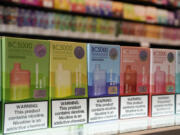 FILE - Varieties of disposable flavored electronic cigarette devices manufactured by EB Design, formerly known as Elf Bar, are displayed at a store in Pinecrest, Fla., Monday, June 26, 2023. A report released by the Centers for Disease Control and Prevention on Thursday, Nov. 2, 2023, shows fewer high school students are vaping. About 10% of high school students said they used electronic cigarettes in the previous month, down from 14% from the same survey conducted last year. Fewer high schools students also smoked cigarettes and cigars. The use of e-cigarettes among middle school students was about the same as last year.