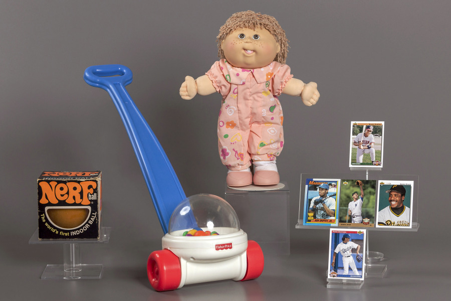 This photo provided by the National Toy Hall of Fame shows their 2023 inductees. From left, NERF, Fisher-Price Corn Popper, Cabbage Patch Kids, and baseball cards. They will be permanently installed at the Toy Hall of Fame in Rochester, NY.