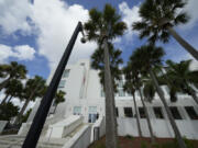 FILE - A police officer stands beside an entrance to the Alto Lee Adams Sr. U.S. Courthouse, Aug. 15, 2023, in Fort Pierce, Fla. A federal judge in Florida has indicated she may delay the start of former President Donald Trump&rsquo;s trial on charges that he hid classified documents at Mar-a-Lago. U.S. District Judge Aileen Cannon questioned prosecutors Wednesday about whether starting the trial in May as scheduled is feasible.
