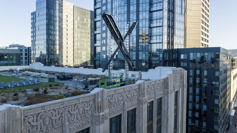 FILE - An &ldquo;X&rdquo; sign rests atop the company headquarters in downtown San Francisco, on July 28, 2023. Elon Musk&rsquo;s social media company, formerly known as Twitter, has filed a lawsuit against liberal advocacy group Media Matters for America.