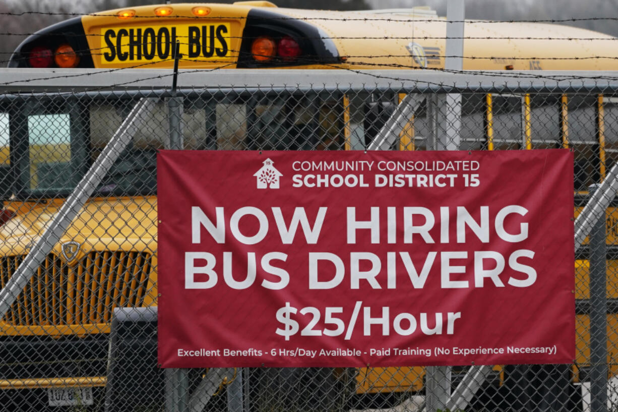 A hiring sign is displayed at a school in Palatine, Ill., Wednesday, Nov. 8, 2023. On Thursday, the Labor Department reports on the number of people who applied for unemployment benefits last week. (AP Photo/Nam Y.
