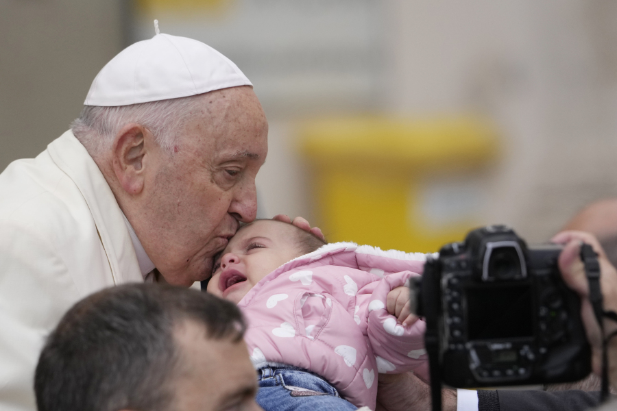 Pope Francis kisses a child at the end of his weekly general audience in St. Peter&rsquo;s Square, at the Vatican, Wednesday, Nov. 22, 2023.