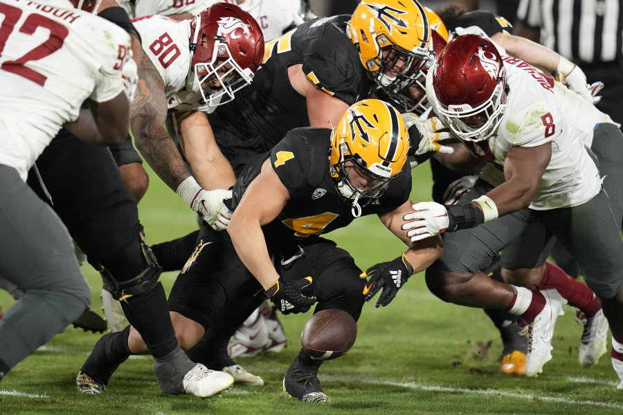 Arizona State running back Cameron Skattebo (4) fumbles the ball as Washington State defensive end Brennan Jackson (80) and linebacker Devin Richardson (8) close in during the second half of an NCAA college football game Saturday, Oct. 28, 2023, in Tempe, Ariz. Skattebo recovered the fumble. (AP Photo/Ross D.