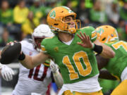 Oregon quarterback Bo Nix (10) looks to throw a pass against Washington State during the first half of an NCAA college football game Saturday, Oct. 21, 2023, in Eugene, Ore.