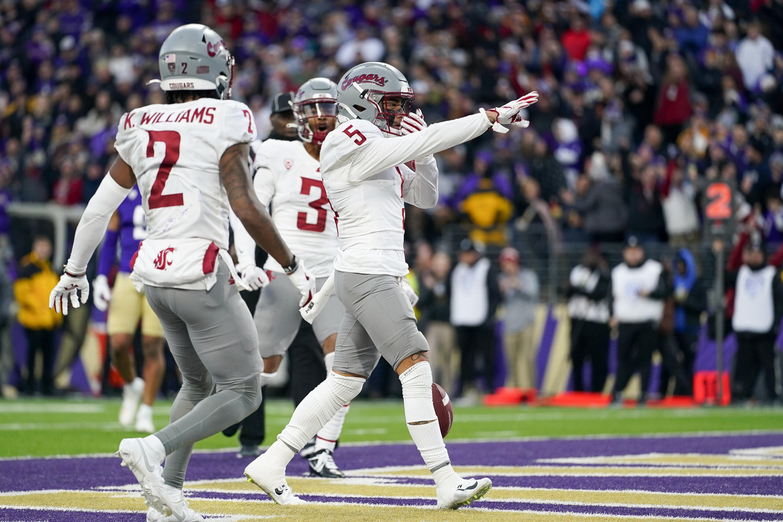 Washington State wide receiver Lincoln Victor (5) points after making a touchdown against Washington during the second half of an NCAA college football game Saturday, Nov. 25, 2023, in Seattle.