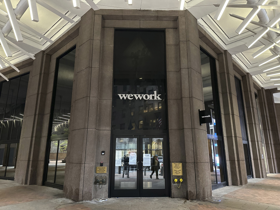 The WeWork logo appears on a building exterior in New York on Tuesday, Nov. 7, 2023. WeWork has filed for Chapter 11 bankruptcy protection, marking a stunning fall for the office sharing company once seen as a Wall Street darling that promised to upend the way people went to work around the world.