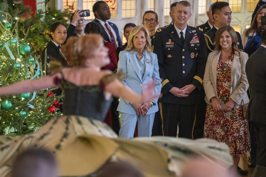 First lady Jill Biden, center, listens to performances by the cast of the North American tour of Disney&rsquo;s stage musical, Frozen, with National Guard families, in the East Room of the White House, Monday, Nov. 27, 2023, in Washington.