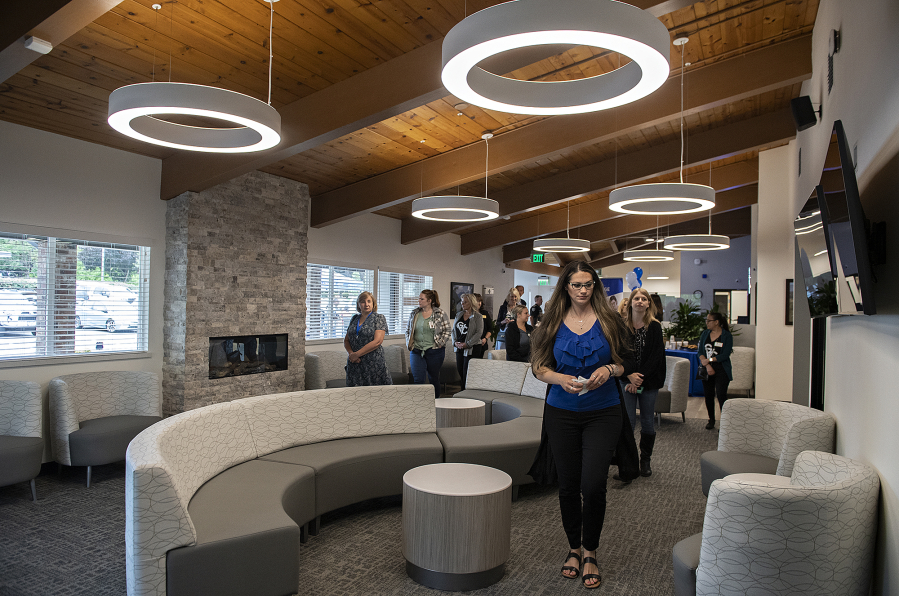 Kelly Ferguson, foreground right, chief operating officer of Columbia River Mental Health Services, leads a tour through the waiting room at the new NorthStar Clinic on Aug. 8.