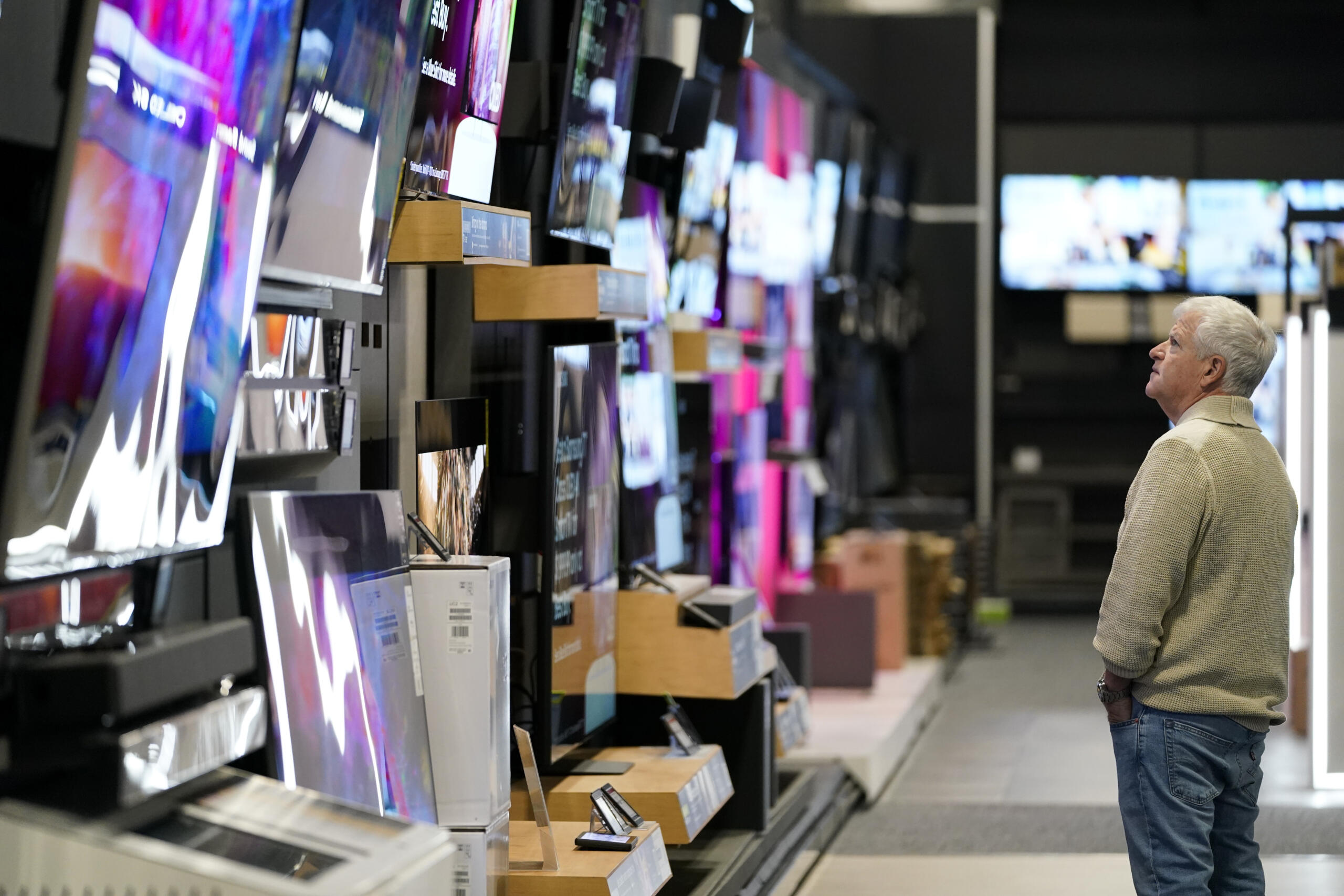 FILE - A customer browses televisions at a Best Buy store on Black Friday, Friday, Nov. 24, 2023, in Charlotte, N.C. If you’re planning on grabbing groceries or doing some other shopping this New Year’s Day, it’s wise to double check stores’ hours.