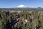 Mount Adams rises above Trout Lake in Klickitat County. The U.S. Geological Survey&rsquo;s Cascades Volcano Observatory is proposing to install five real-time monitoring stations around the volcano to detect lahars, which would give neighboring communities time to evacuate.