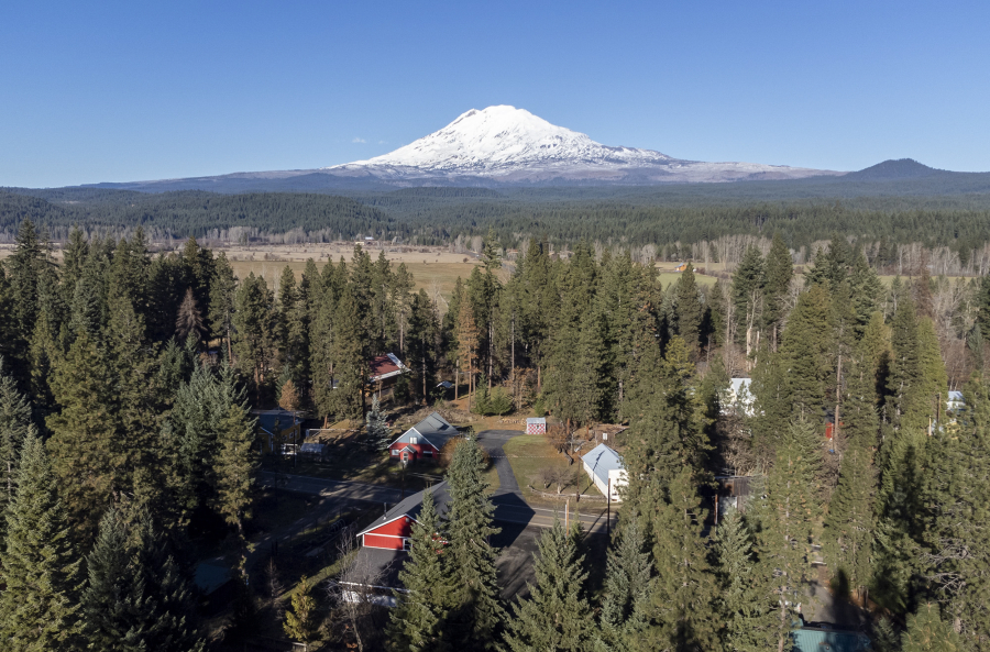 Mount Adams rises above Trout Lake in Klickitat County. The U.S. Geological Survey&rsquo;s Cascades Volcano Observatory is proposing to install five real-time monitoring stations around the volcano to detect lahars, which would give neighboring communities time to evacuate.