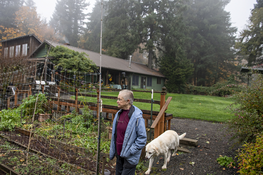 Valerie Alexander, owner of Coyote Ridge Ranch, walks through one of the gardens on her property while joined by family dog Kelo, 15, near La Center.