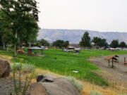 A grassy area slopes to a swimming area in the John Day River at LePage Park, along Interstate 84 in north central Oregon.