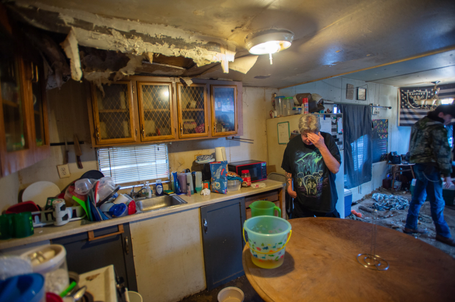 Casey Jewell, left, and her son, Charley Jewell, live in a mobile home with a large hole in the kitchen ceiling. Cassie Jewell said the hole formed last spring and has since grown.