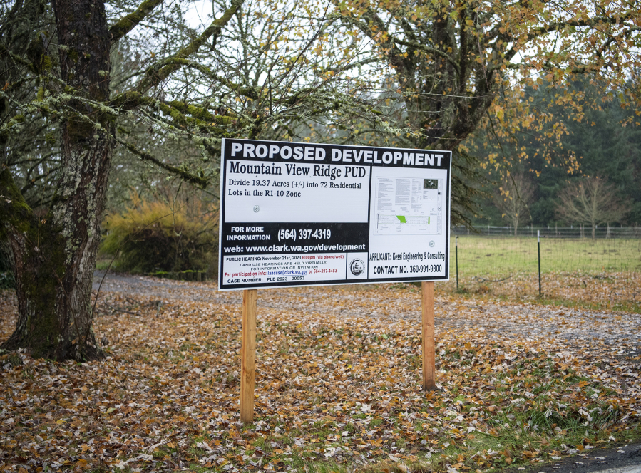 A sign informing Ridgefield area residents of a proposed development sits in the front yard of a house on Northeast 29th Avenue. The developer has proposed splitting three parcels and subdivide them into 72 single-family home lots.