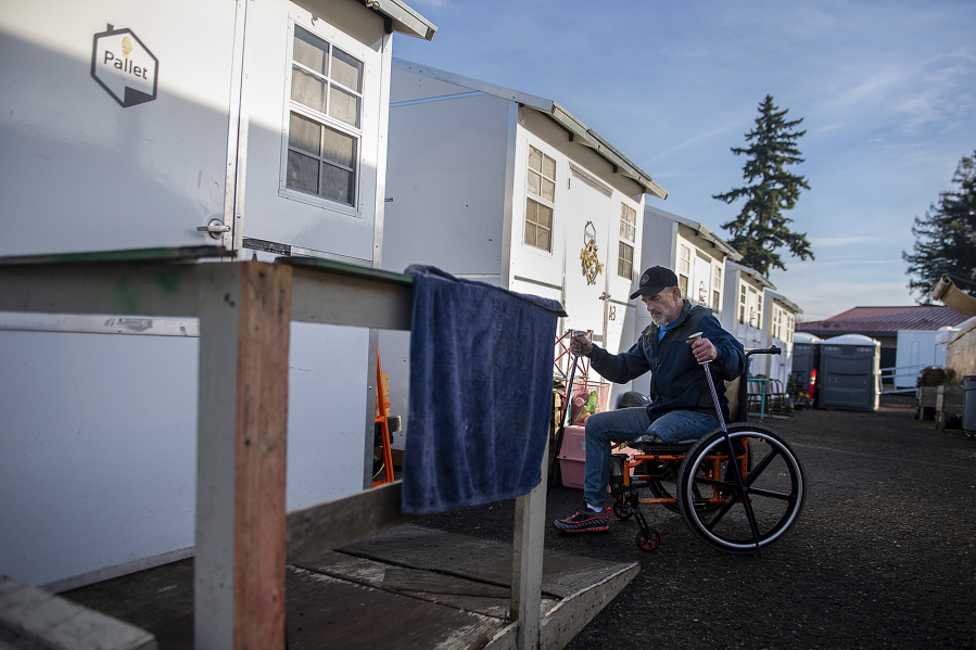 Jimmy Howland of Vancouver, who had his leg amputated in 2020, navigates the small ramp he built for his unit at Hope Village in Vancouver.  At top, a  man has his vitals checked at the Evergreen Crossing respite medical clinic in Portland.
