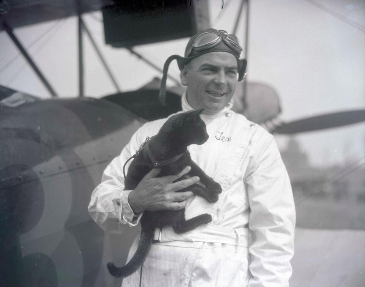 Barnstorming pilot Tex Rankin with Alba Barba, a black cat loaned to him as a &ldquo;jinx&rdquo; for a cross-country air race from New York to Los Angeles. Rankin&rsquo;s plane also bore the number 13.