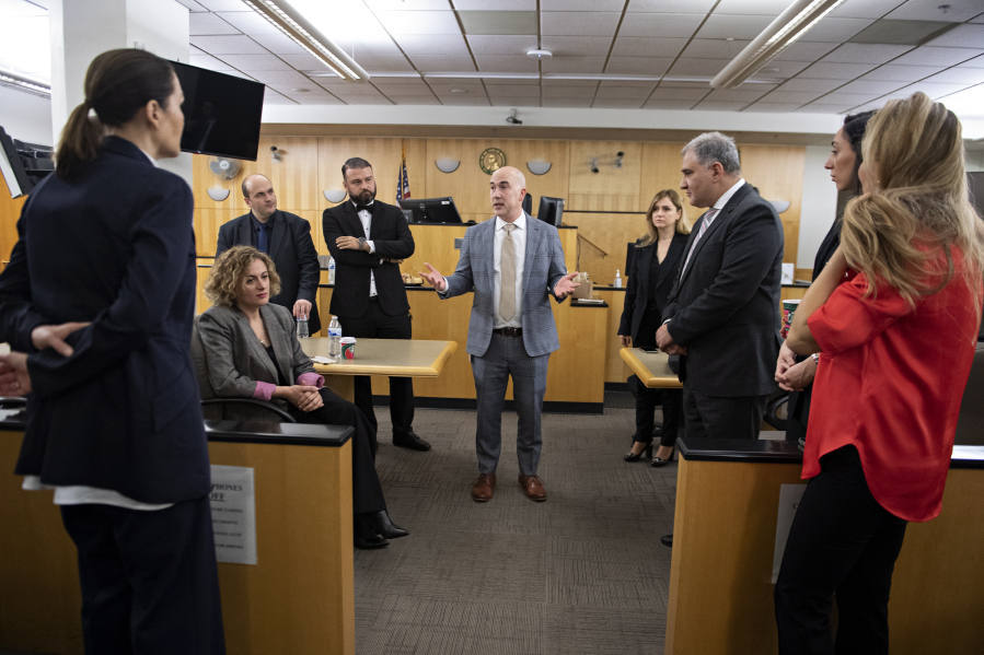 Clark County District Court administrator Bryan Farrell, center in gray, talks with law officials from the country of Georgia at the Clark County Courthouse on Tuesday morning.