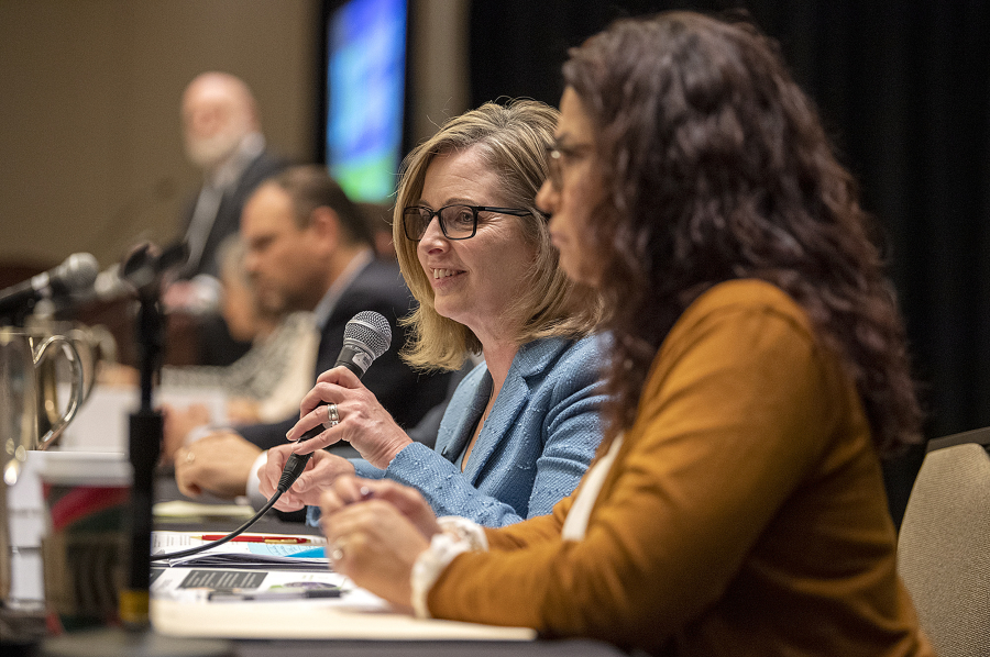 Sen. Annette Cleveland, D-Vancouver, foreground left, speaks to the crowd while Rep. Monica Stonier, D-Vancouver, right, listens during a 2024 legislative outlook at the Hilton Vancouver Washington on Friday.